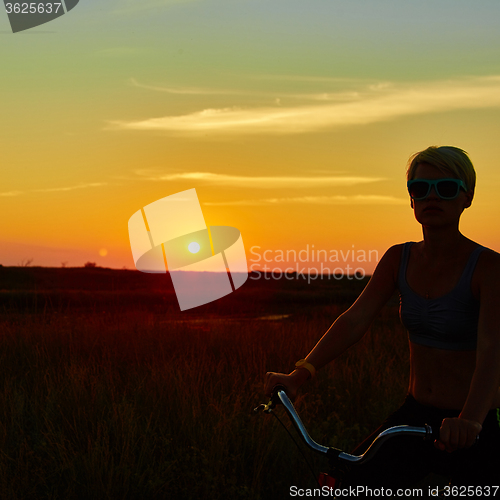 Image of Biker-girl at the sunset