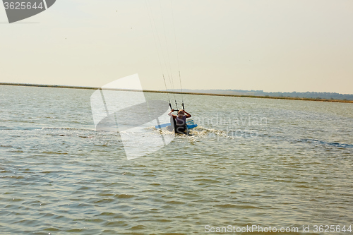 Image of young woman kite-surfer