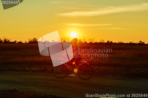 Image of Biker-girl at the sunset