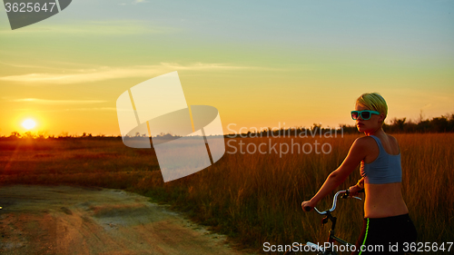 Image of Biker-girl at the sunset