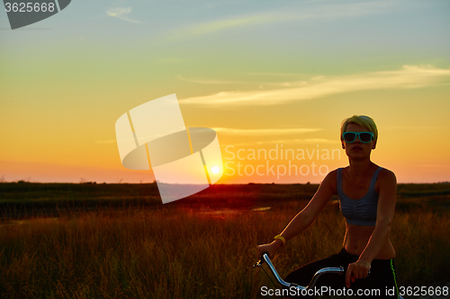 Image of Biker-girl at the sunset