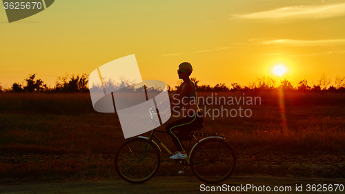 Image of Biker-girl at the sunset