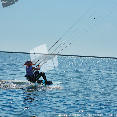 Image of young woman kite-surfer