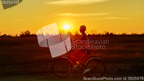 Image of Biker-girl at the sunset