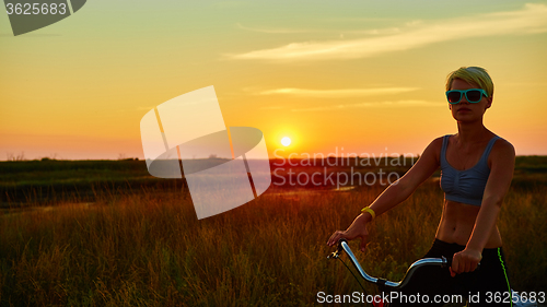 Image of Biker-girl at the sunset