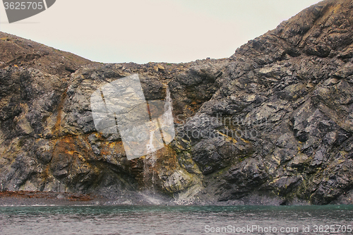 Image of Rocky cliffs of Novaya Zemlya archipelago in Barents sea and waterfalls