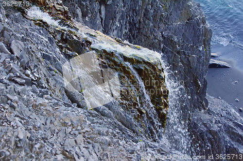 Image of Rocky cliffs of Novaya Zemlya archipelago in Barents sea and waterfalls