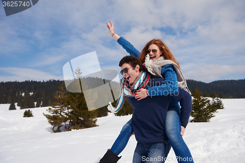 Image of happy young couple having fun on fresh show on winter vacation