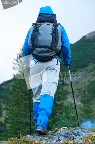 Image of advanture man with backpack hiking