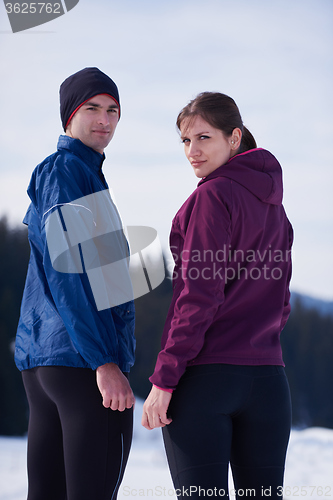 Image of couple jogging outside on snow