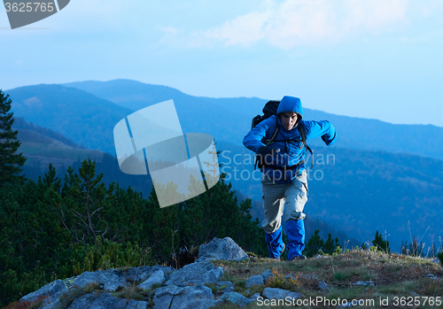 Image of advanture man with backpack hiking