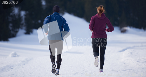 Image of couple jogging outside on snow