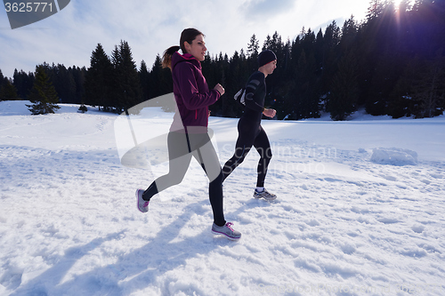 Image of couple jogging outside on snow