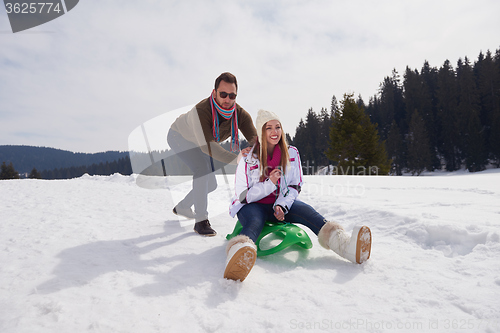 Image of happy young couple having fun on fresh show on winter vacation