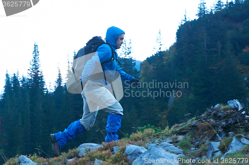 Image of advanture man with backpack hiking