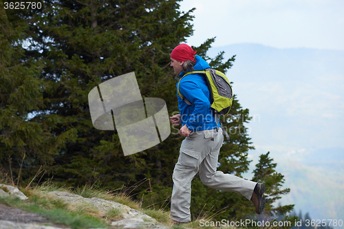 Image of advanture man with backpack hiking