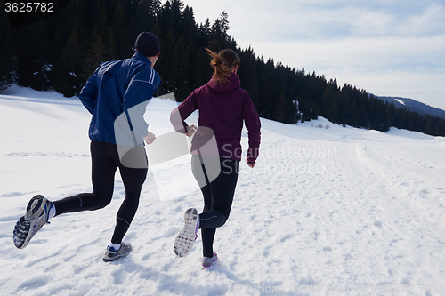 Image of couple jogging outside on snow