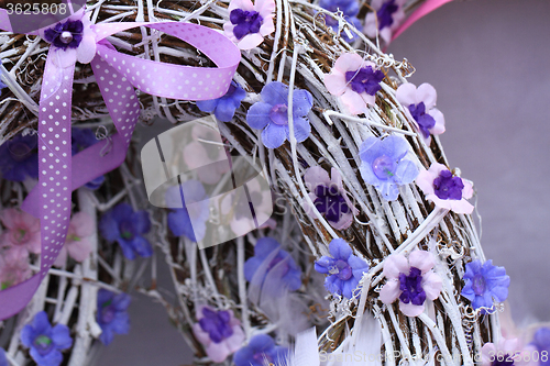 Image of spring violet plastic flowers decoration