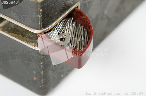 Image of Open box with needles on the trunk of an old gramophone isolated on a white background