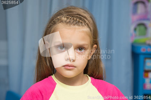 Image of Upset five year old girl with tearful eyes
