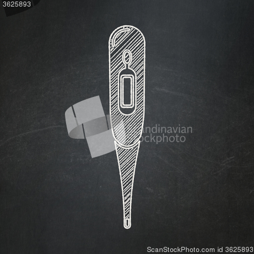 Image of Health concept: Thermometer on chalkboard background