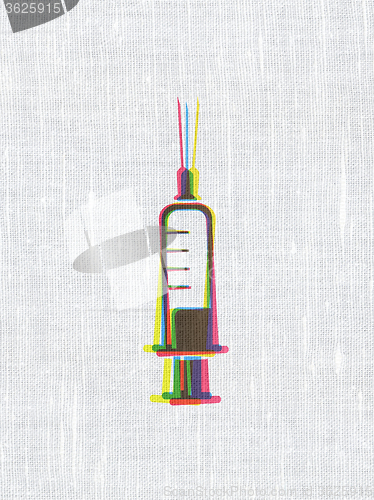 Image of Medicine concept: Syringe on fabric texture background