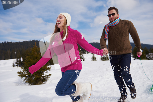 Image of happy young couple having fun on fresh show on winter vacation