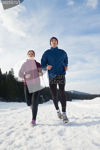 Image of couple jogging outside on snow