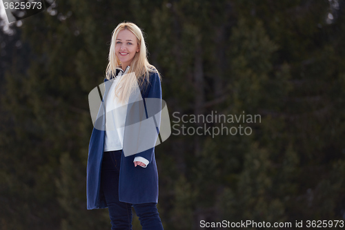 Image of portrait of beautiful young redhair woman in snow scenery