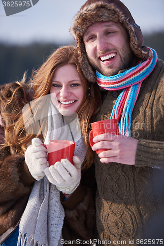 Image of couple drink warm tea at winter