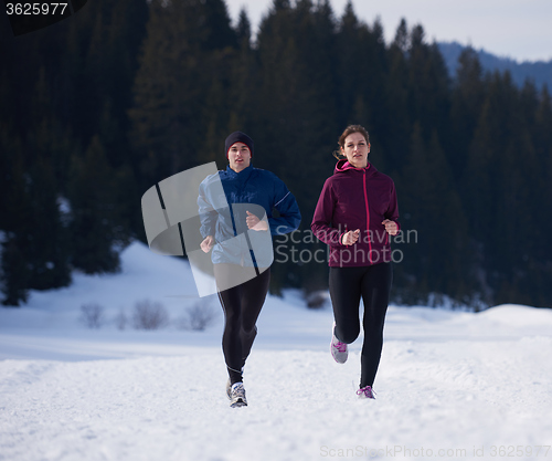 Image of couple jogging outside on snow