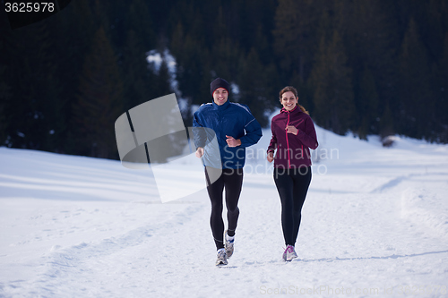 Image of couple jogging outside on snow