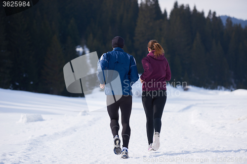 Image of couple jogging outside on snow