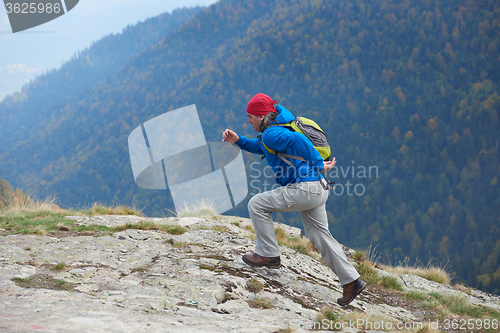 Image of advanture man with backpack hiking