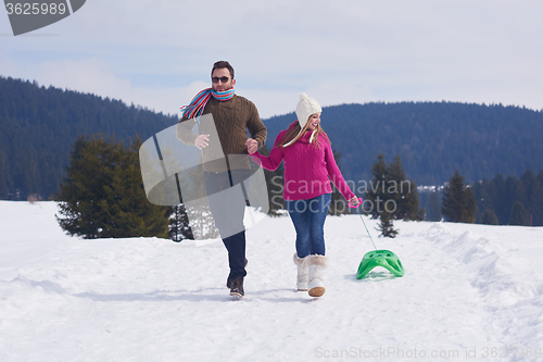 Image of happy young couple having fun on fresh show on winter vacation