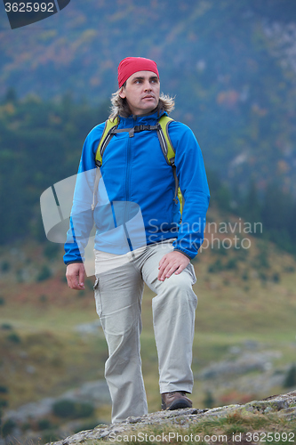 Image of advanture man with backpack hiking