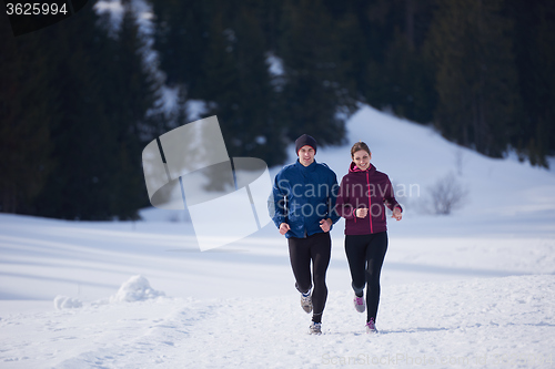 Image of couple jogging outside on snow