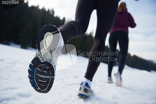 Image of couple jogging outside on snow