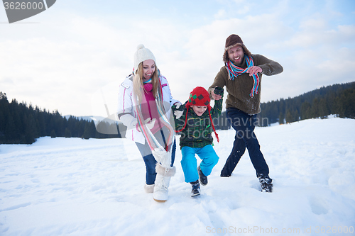 Image of happy family playing together in snow at winter