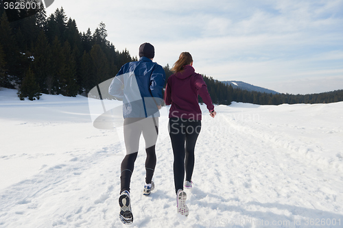 Image of couple jogging outside on snow