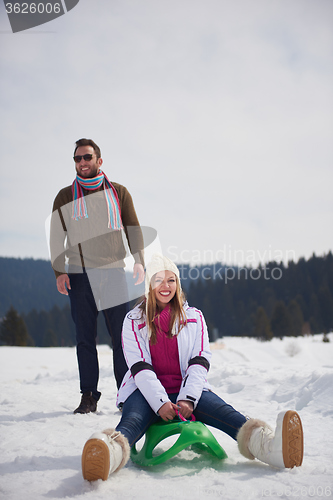 Image of happy young couple having fun on fresh show on winter vacation