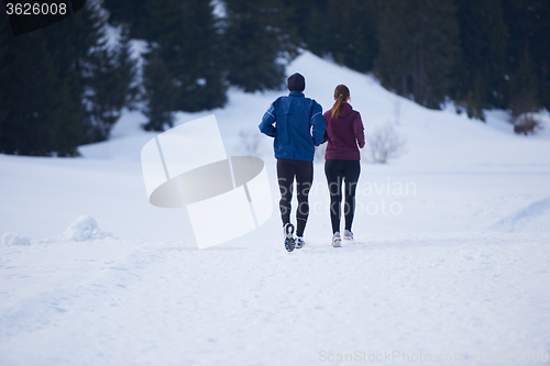 Image of couple jogging outside on snow