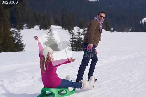 Image of happy young couple having fun on fresh show on winter vacation