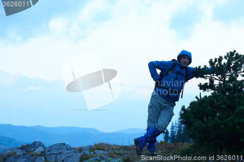 Image of advanture man with backpack hiking