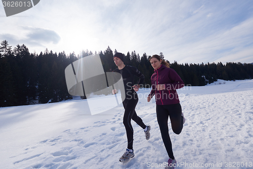 Image of couple jogging outside on snow