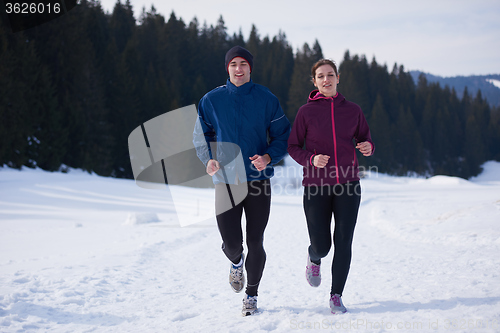 Image of couple jogging outside on snow