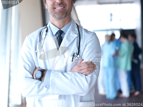 Image of group of medical staff at hospital, doctor in front of team