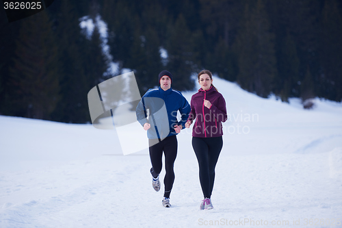 Image of couple jogging outside on snow