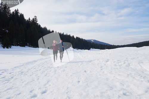 Image of couple jogging outside on snow