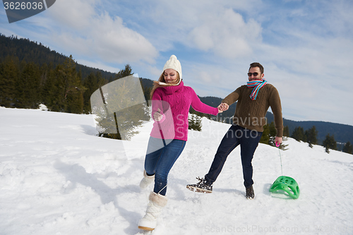 Image of happy young couple having fun on fresh show on winter vacation